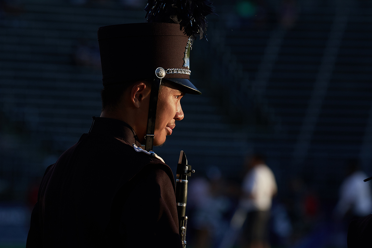 Member of the UConn Marching Band waits for the football team to run onto the field.